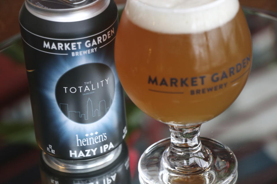 Cleveland-based Market Garden Brewery has partnered with Midwest grocery chain Heinen's to sell cans of hazy IPA called "The Totality," shown in this photo, ahead of the total solar eclipse on April 8, 2024. (Danni Haseley/Market Garden Brewery via AP)