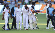 Indian players celebrate after defeating Australia by three wickets on the final day of the fourth cricket test at the Gabba, Brisbane, Australia, Tuesday, Jan. 19, 2021.India won the four test series 2-1. (AP Photo/Tertius Pickard)