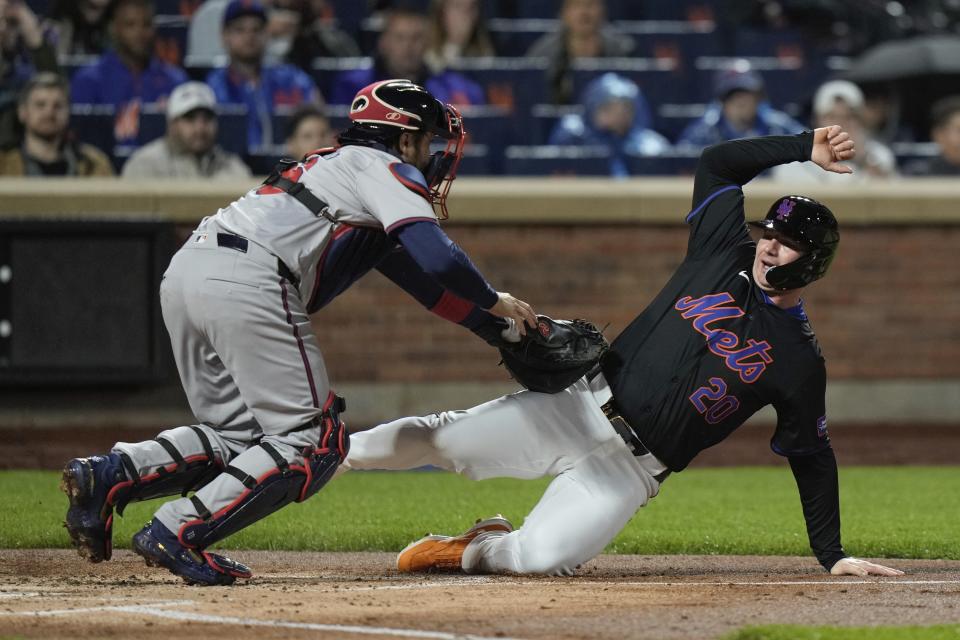 Atlanta Braves catcher Travis d'Arnaud tags out New York Mets' Pete Alonso at home plate during the second inning of a baseball game Friday, May 10, 2024, in New York. (AP Photo/Frank Franklin II)