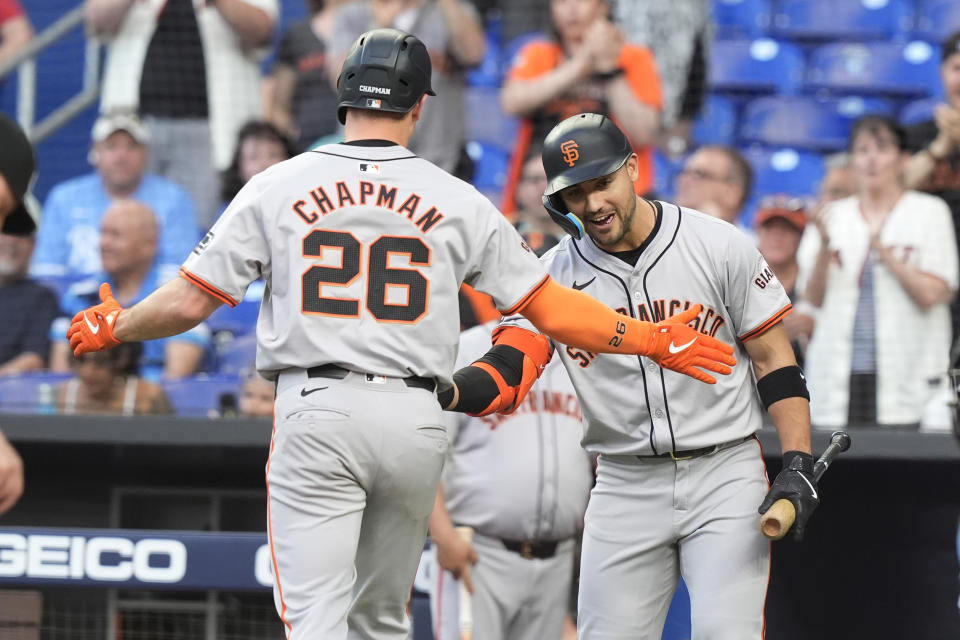 San Francisco Giants' Michael Conforto congratulates Matt Chapman (26) after Chapman hit a home run during the third inning of a baseball game against the Miami Marlins, Tuesday, April 16, 2024, in Miami. (AP Photo/Marta Lavandier)