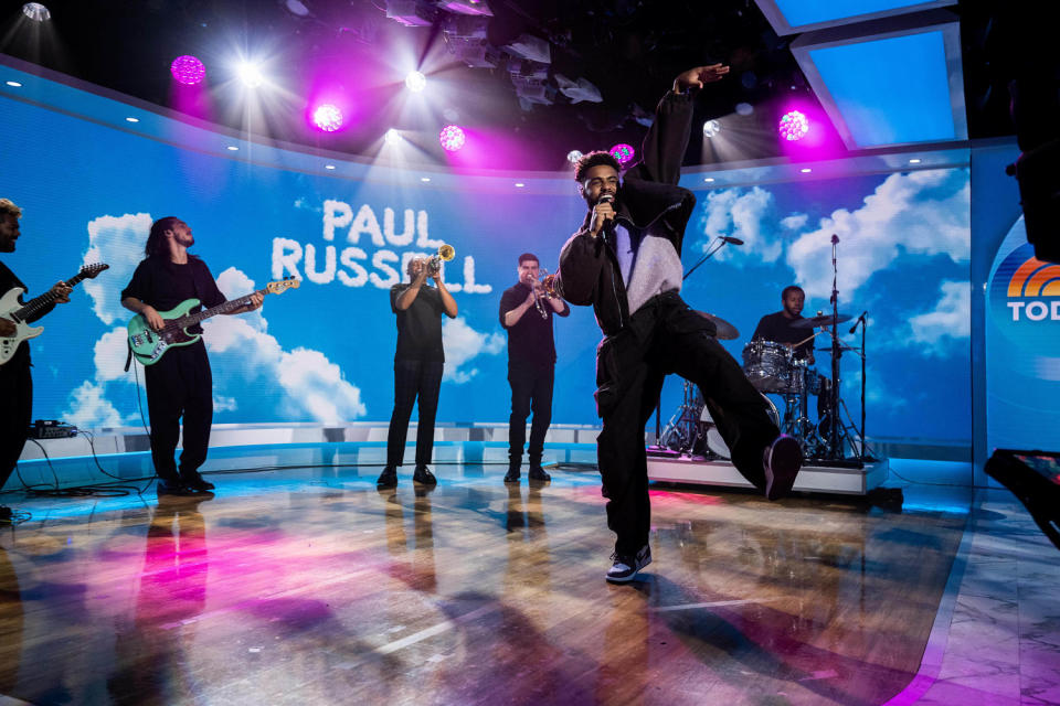 Russell stands in front of a band and sings. (Nathan Congleton / TODAY)