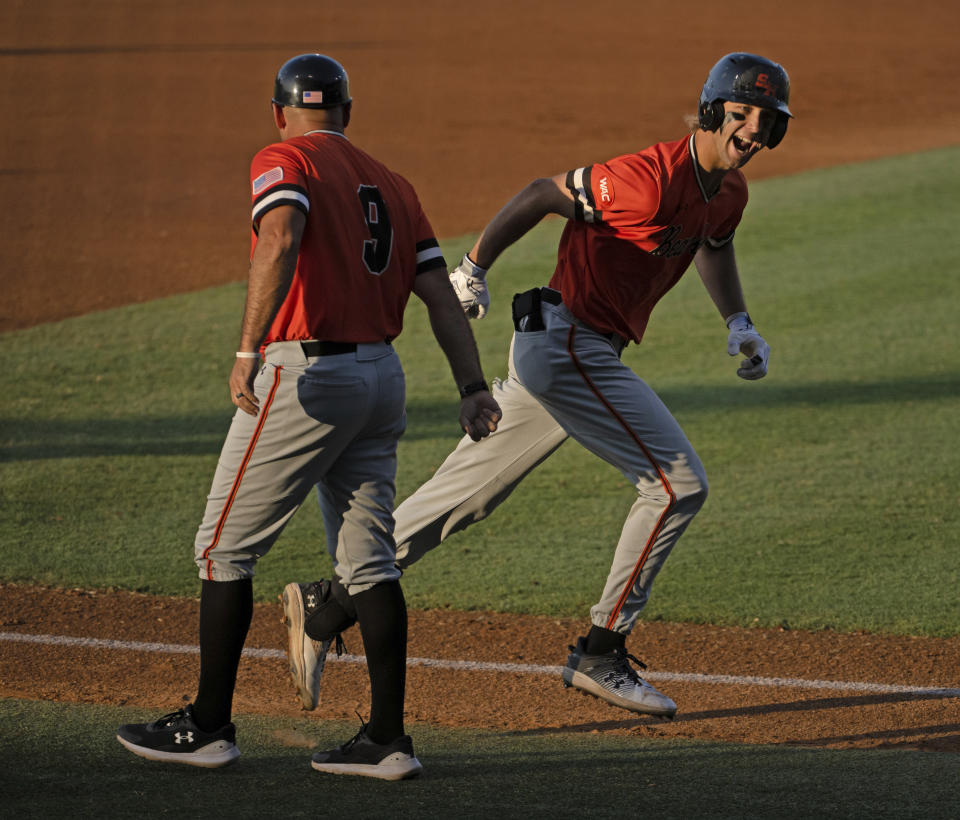 Sam Houston State's Justin Wishkoski, right, rounds third base on a two-run home run against Oregon State in an NCAA college baseball tournament regional game Friday, June 2, 2023, in Baton Rouge, La. (Hilary Scheinuk/The Advocate via AP)