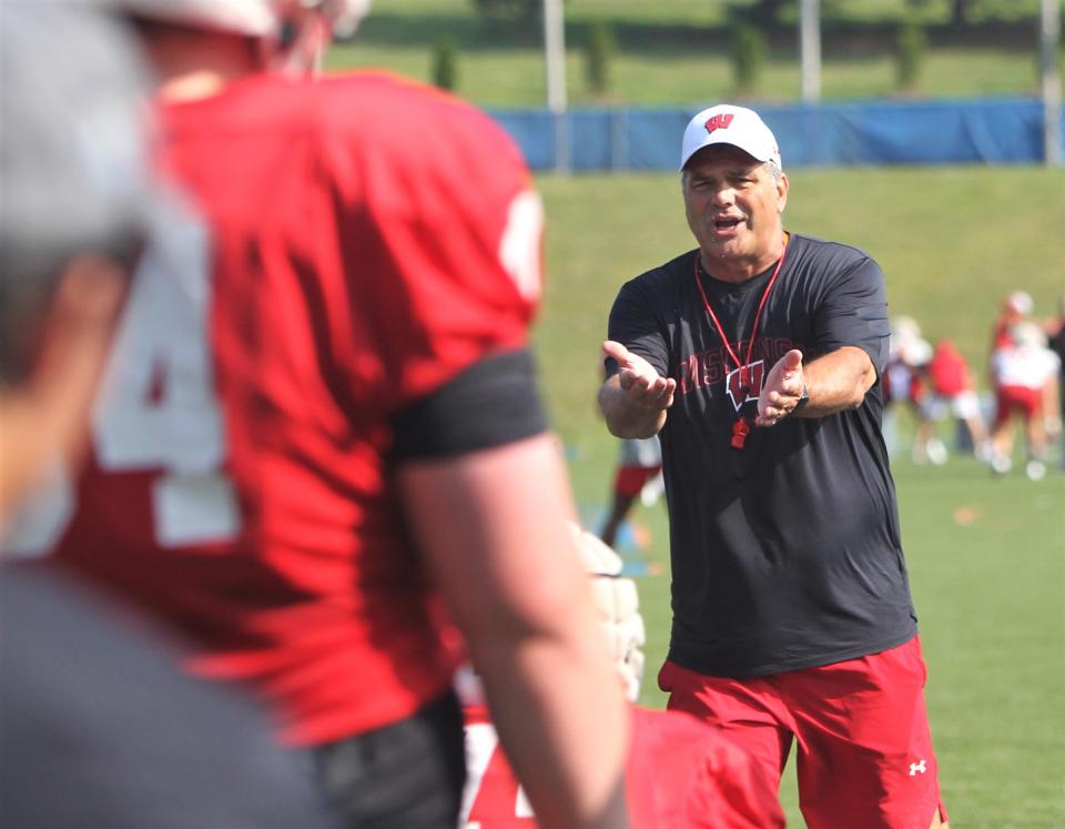 Offensive line coach Jack Bicknell Jr. talks with Wisconsin players during practice on Aug. 6, 2023.