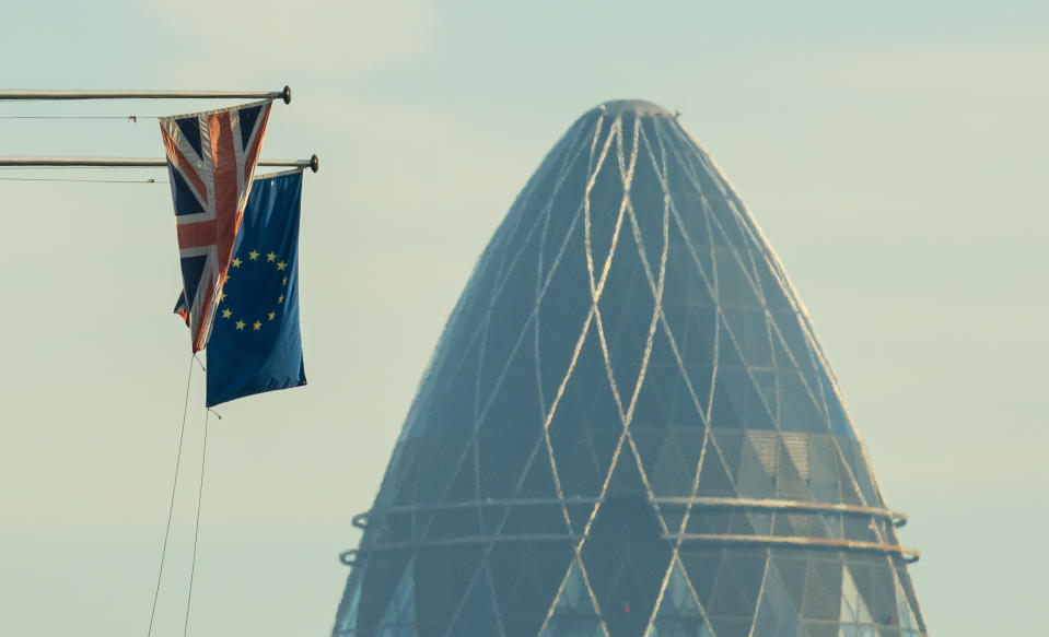 A UK flag flies alongside an EU flag in the City of London (Getty)