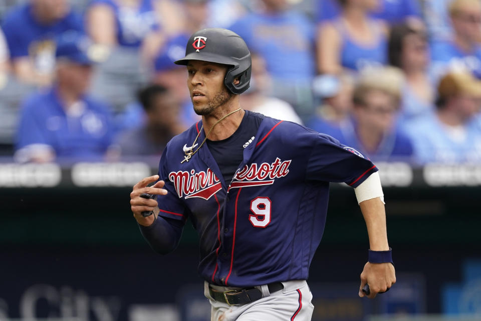 Minnesota Twins' Andrelton Simmons runs home to score on a double by Miguel Sano during the third inning of a baseball game against the Kansas City Royals Sunday, June 6, 2021, in Kansas City, Mo. (AP Photo/Charlie Riedel)