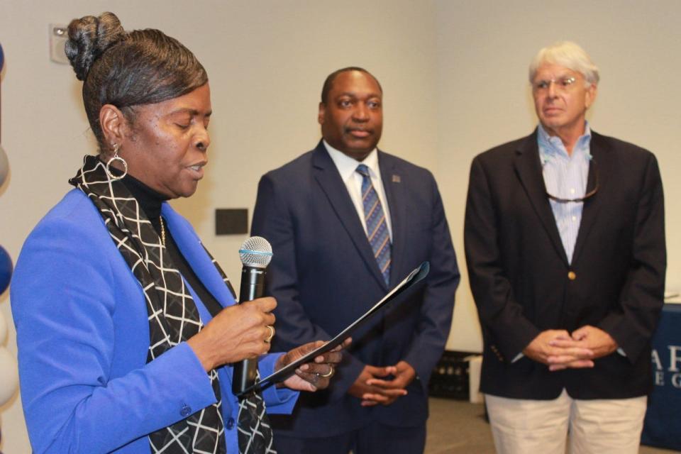 Karen Cole-Smith, Ph.D. left, reads a proclamation to  Paul Broadie II, Ph.D., center, and Jackson Sasser, Ph.D., right, during the 20th Annual Santa Fe College East Gainesville Initiative Community Forum last Thursday.