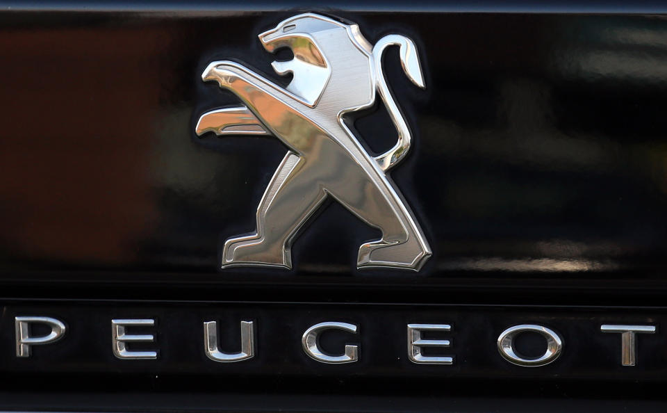 A Peugeot logo pictured on a car in Bayonne, southwestern France, Thursday, Oct.31, 2019.The boards of Fiat Chrysler and PSA Peugeot announced Thursday fast-moving plans to merge the two companies creating the world's fourth-largest automaker with enough scale to confront "the new era in mobility". (AP Photo/Bob Edme)