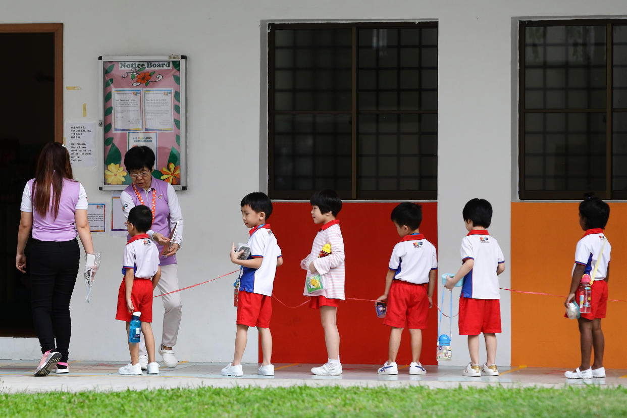 Children attending PAP Community Foundation (PCF) Sparkletots preschool are seen praticising safe distancing on 30 March, 2020 here. (PHOTO: Getty Images)