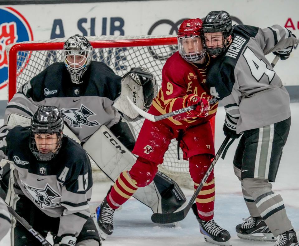 PC's Guillaume Richard defends BC's Ryan Leonard in front of goalie John Driscoll.