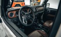 <p>Inside, the seats are finished in a special Katzkin Amaretto Brown leather with orange stitching, which also covers the armrests and dashboard.</p>