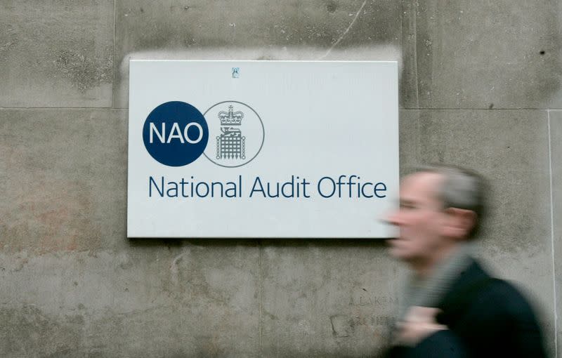 A pedestrian walks past Britain's National Audit Office in London