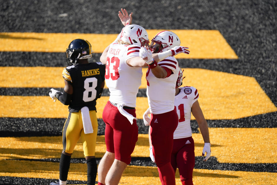 Nebraska quarterback Adrian Martinez, right, celebrates with teammate Travis Vokolek (83) after scoring on a 1-yard touchdown run during the first half of an NCAA college football game against Iowa, Friday, Nov. 27, 2020, in Iowa City, Iowa. (AP Photo/Charlie Neibergall)