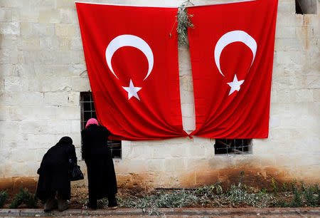 Women inspect a mosque which was hit by a rocket fired from Syria, in the border town of Kilis, Turkey January 25, 2018. REUTERS/Umit Bektas