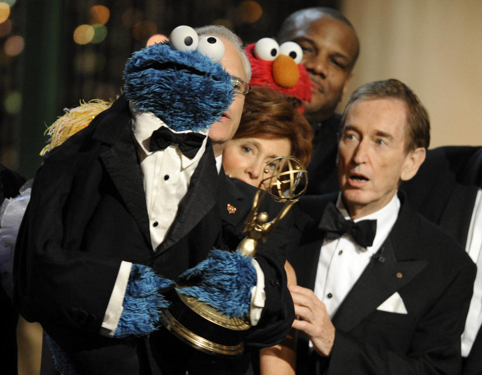 FILE - Bob McGrath, right, looks at the Cookie Monster as they accept the Lifetime Achievement Award for '