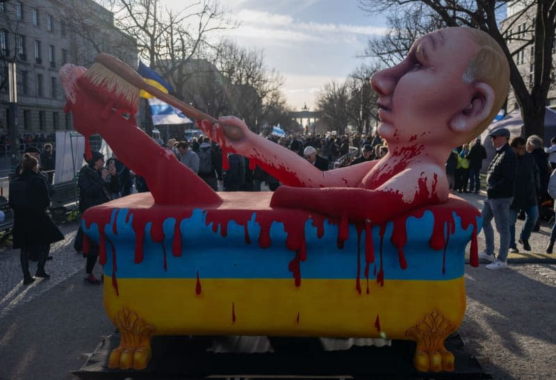 A figure depicting Russian President Vladimir Putin in a blood bathtub stands at a rally entitled "Stop Putin, war, lies and repression" organized by the alliance "Democracy - Yes"  against President Putin's policies one month after the death of Kremlin critic Navalny. Monika Skolimowska/dpa