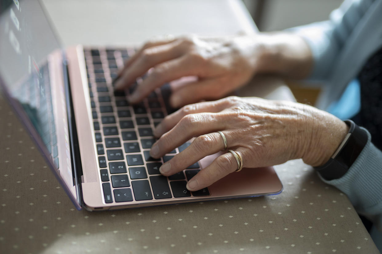 RADEVORMWALD, GERMANY - MAY 12:  In this photo illustration old hand are working on a laptop an old woman is using a laptop on May 12, 2020 in Radevormwald, Germany. (Photo by Ute Grabowsky/Photothek via Getty Images)