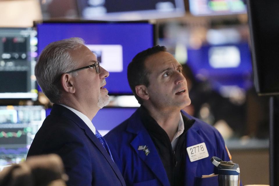 FILE — Traders work on the floor at the New York Stock Exchange, Feb. 1, 2023. Average Wall Street bonuses dropped sharply last year amid lagging profits and recession fears, New York state's comptroller reported Thursday, March 30.(AP Photo/Seth Wenig, File)