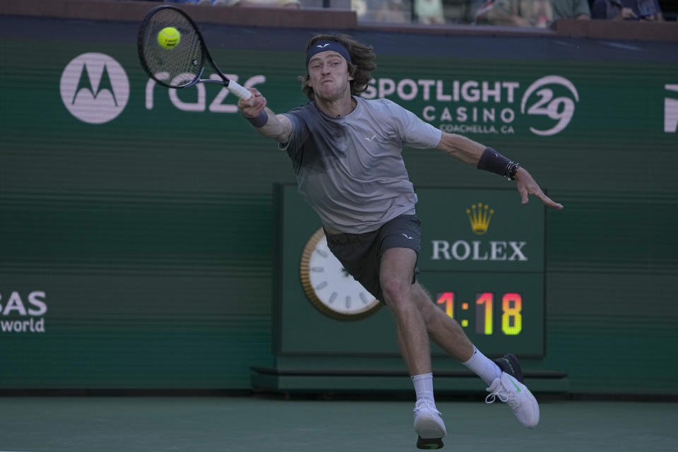 Andrey Rublev, of Russia, returns a shot against Andy Murray, of Great Britain, at the BNP Paribas Open tennis tournament in Indian Wells, Calif., Friday, March 8, 2024. (AP Photo/Mark J. Terrill)