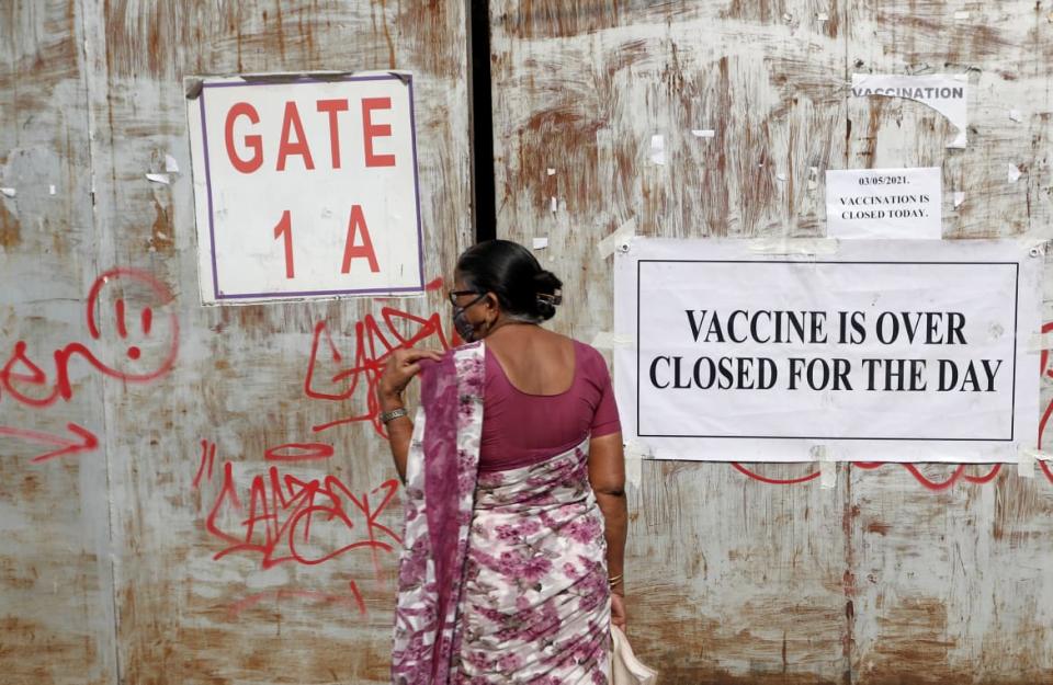 <div class="inline-image__caption"><p>In Mumbai, India, a woman stands in front of a COVID-19 vaccination centre that was closed because of a shortage of vaccines, May 3 2021. </p></div> <div class="inline-image__credit">REUTERS/Francis Mascarenhas</div>
