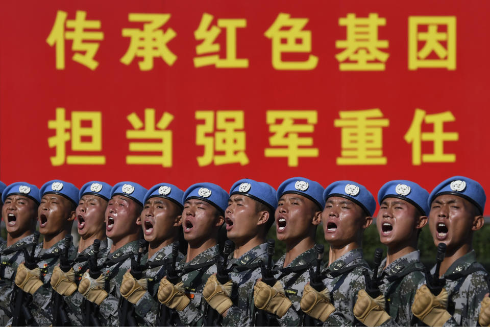 FILE - In this Sept. 25, 2019, file photo, soldiers practice marching in formation ahead of the military parade to celebrate the 70th anniversary of the founding of the People's Republic of China in Beijing. Japan's annual defense paper, approved Friday, Sept. 27, 2019, says Defense Ministry highlighted space security as priority, citing growing space activity by China and Russia as threats. (Naohiko Hatta/Pool Photo via AP, File)