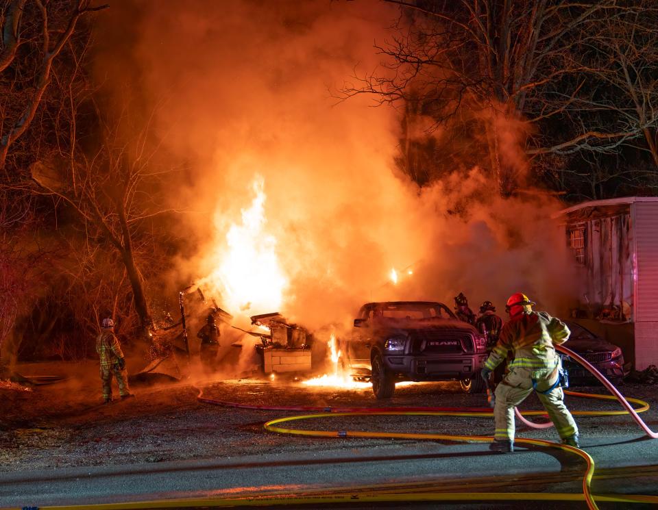 Firefighters battle a garage fire on the 100 block of Fish and Game Road, Friday, Dec. 22, 2023, in Oxford Township.