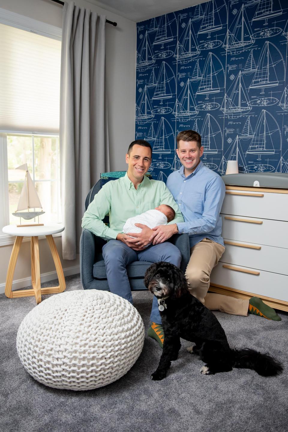 Michael Charles DeGrandpre and Richard Alan Pezzillo Jr. hold their newborn son Charles Vincent DeGrandpre Pezzillo in their Warwick, Rhode Island, home on Dec. 22, 2023. Their baby came into the world thanks to a surrogate mom, Rockland teacher Rachel Mack of Middleboro.