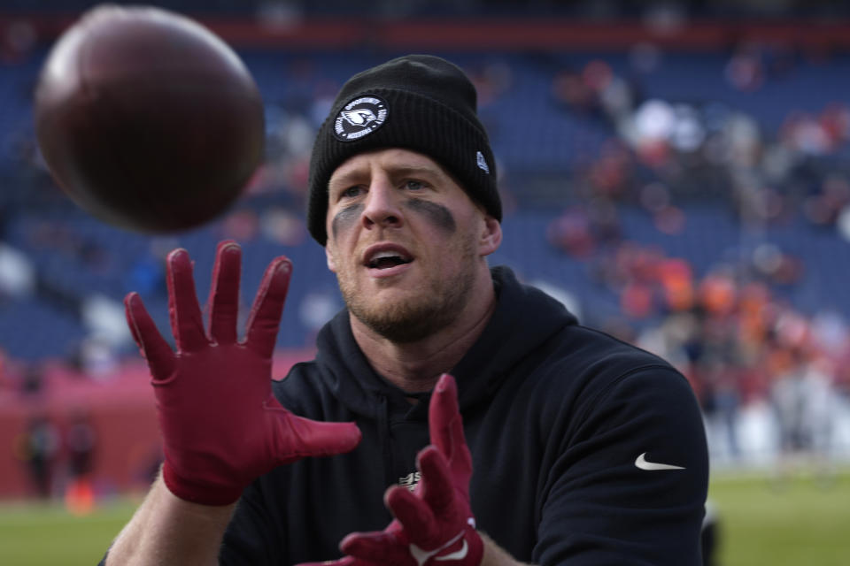 Arizona Cardinals defensive end J.J. Watt plays catch with fans prior to an NFL football game against the Denver Broncos, Sunday, Dec. 18, 2022, in Denver. (AP Photo/David Zalubowski)