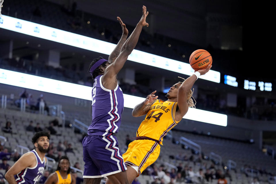 Arizona State guard Adam Miller (44) shoots as TCU forward Emanuel Miller (2) defends in the second half of an NCAA college basketball game in Fort Worth, Texas, Saturday, Dec. 16, 2023. (AP Photo/Tony Gutierrez)