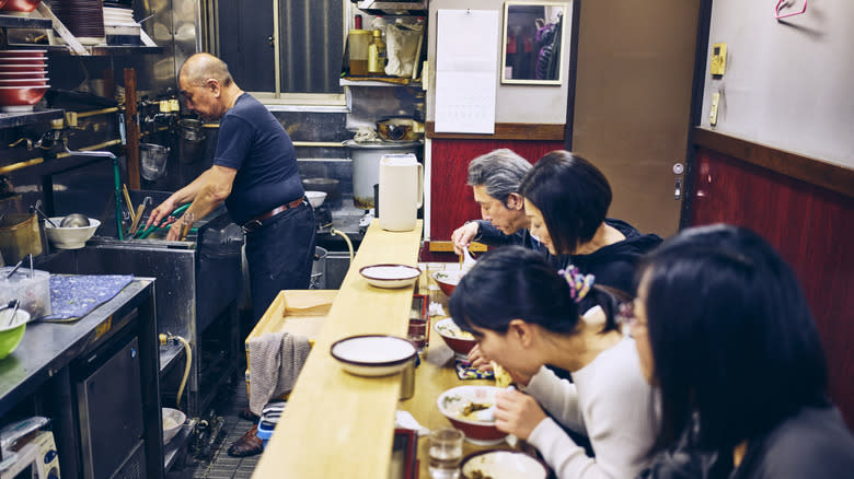 Customers at ramen restaurant counter