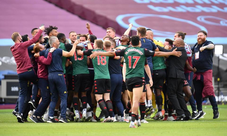 Aston Villa players and staff celebrate finding out they are staying in the Premier League after the 1-1 draw at West Ham on the last day of the season