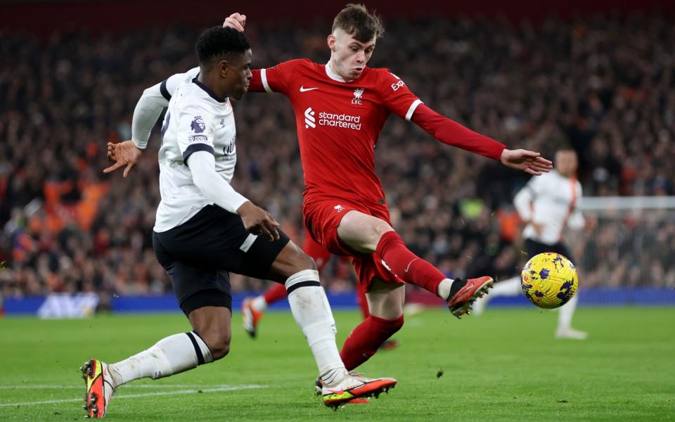 Liverpool's Conor Bradley (right) is challenged by Chiedozie Ogbene of Luton Town/Andy Robertson: Liverpool players must put aside emotions over Jurgen Klopp's exit