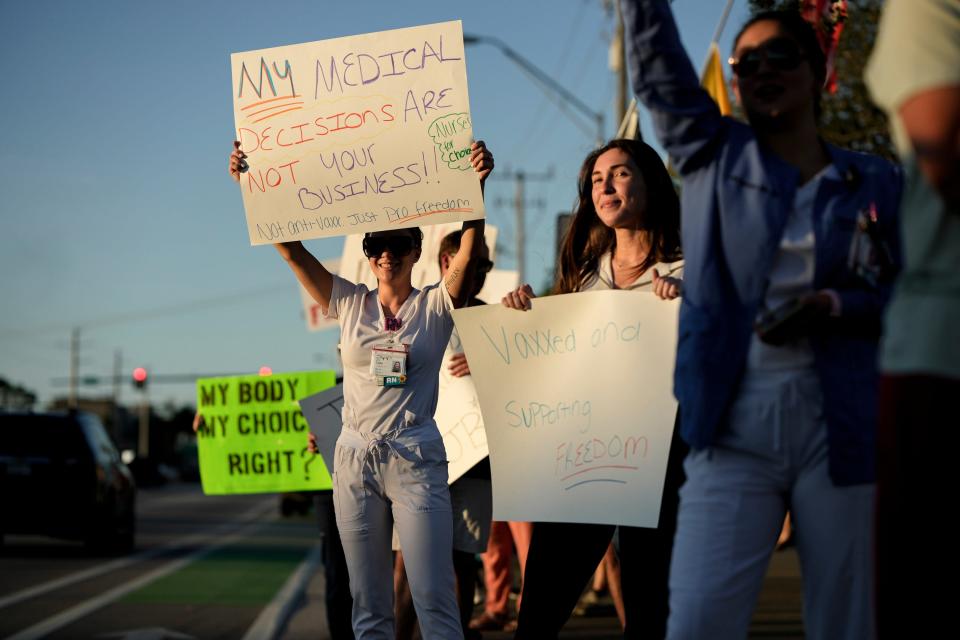 Demonstrators protest on the Roosevelt Bridge against the federal COVID-19 vaccine mandate on Nov. 26, 2021, in Stuart, Fla. The protest was in support of health care workers who will face unemployment because of the mandate.