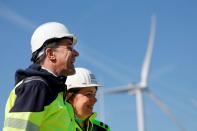 Dutch PM Mark Rutte and CEO of TenneT Manon van Beek in front of a wind turbine at de Maasvlakte