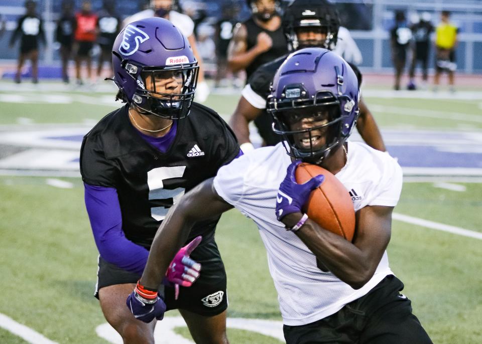 Stonehill's Ifeanyi Ijezie, left, chases receiver Chris Domercant during the first day of practice at W.B. Mason Stadium on Monday, Aug. 7, 2023.