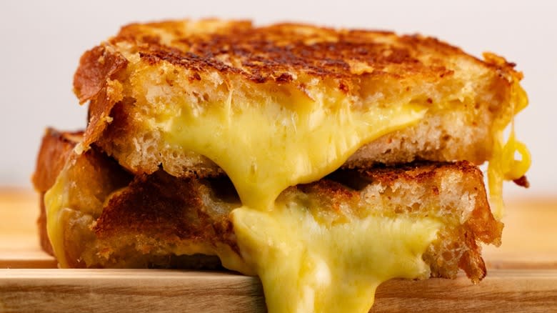Closeup of a grilled cheese sandwich on a wooden board