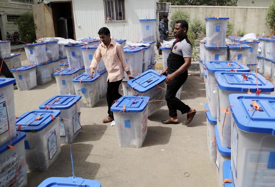 Electoral workers carry ballot boxes at a counting center in Basra, Iraq's second-largest city, 340 miles (550 kilometers) southeast of Baghdad, Iraq, Thursday, May 1, 2014. Iraq voted Wednesday in its first nationwide election since U.S. troops withdrew in 2011, with Prime Minister Nouri al-Maliki confident of victory and even offering an olive branch to his critics by inviting them to join him in a governing coalition. (AP Photo/Nabil Al-Jurani)