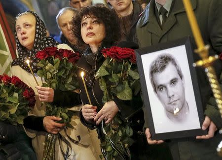 People attend the funeral ceremony of Ukrainian serviceman Ihor Branovytsky, who was killed in the fighting in eastern Ukraine, at Mikhailovsky Zlatoverkhy Cathedral (St. Michael's Golden-Domed Cathedral) in central Kiev, in this file picture taken April 3, 2015. REUTERS/Gleb Garanich/Files