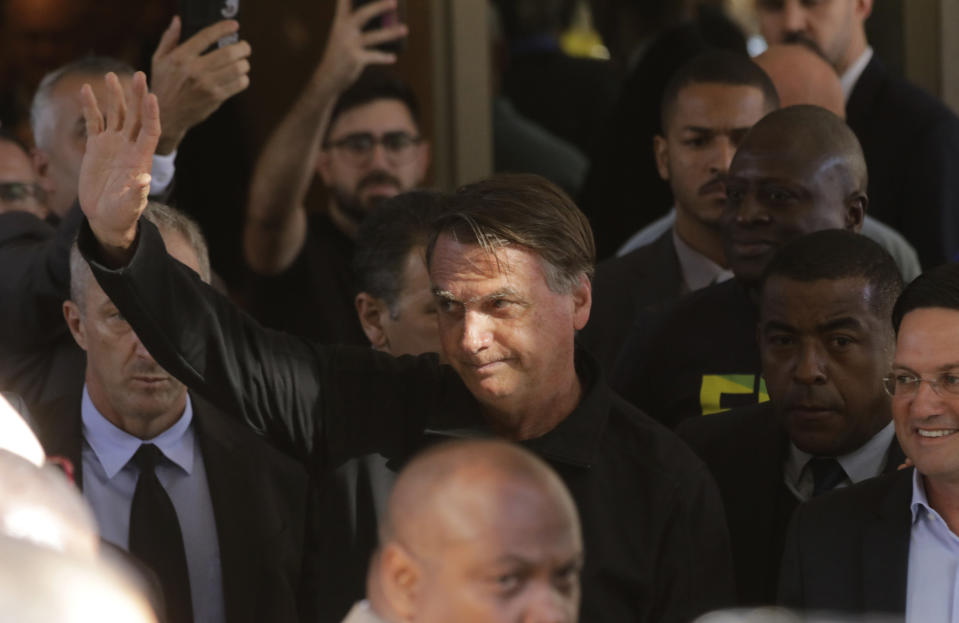 Brazil's former President Jair Bolsonaro greets supporters outside the Liberal Party's headquarters in Brasilia, Brazil, Thursday, March 30, 2023. Bolsonaro arrived back in Brazil on Thursday after a three-month stay in Florida. (AP Photo/Gustavo Moreno)