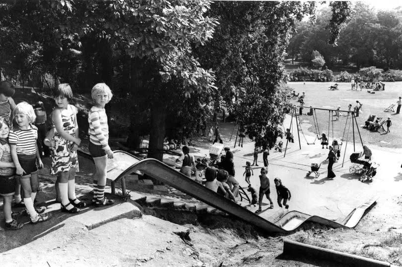 Children queue to use the long slide at Roath Park during the school  summer  break. school holidays. August 1977.