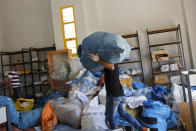 Palestinian postal workers sift through eight years' worth of undelivered mail held by Israel, at the post office in the West Bank city of Jericho, Sunday, Aug. 19, 2018. In recent days the postal staff has been sorting through tons of undelivered mail in a room packed with letters, boxes and even a wheelchair. Postal official Ramadan Ghazawi says Israel did not respect a 2008 agreement to send and receive mail directly through Jordan. Israeli officials say the one-time release of 10.5 tons of mail was a "gesture." (AP Photo/Nasser Shiyoukhi)