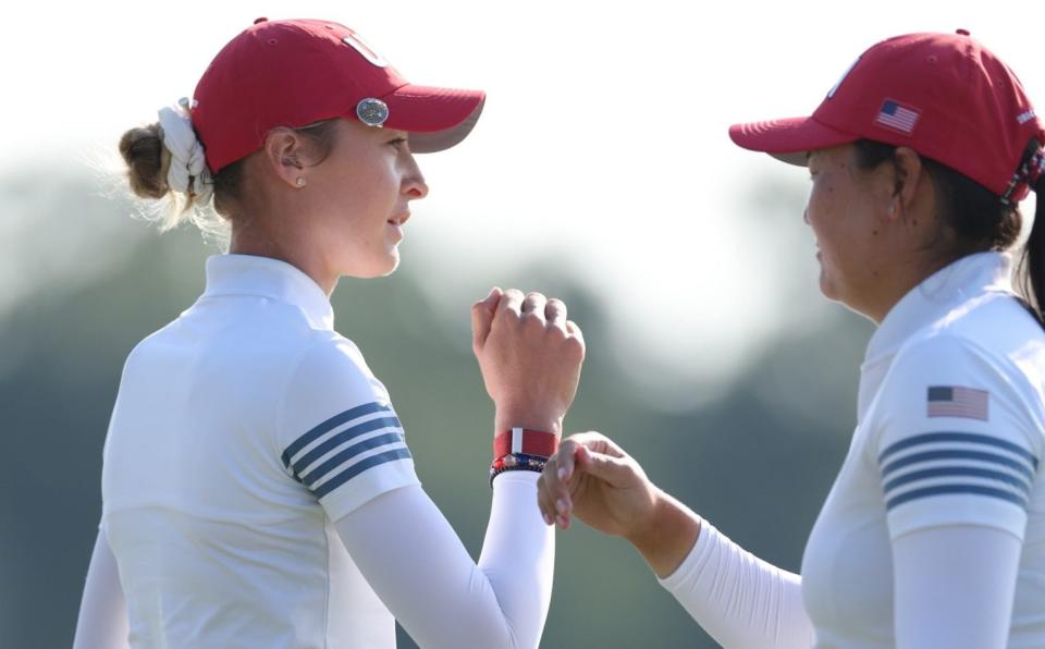 Allisen Corpuz and Nelly Korda of Team United States react to her putt on the 10th green