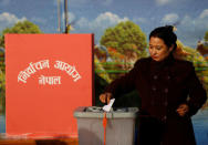 A woman casts her vote during the parliamentary and provincial elections in Bhaktapur, Nepal December 7, 2017. REUTERS/Navesh Chitrakar