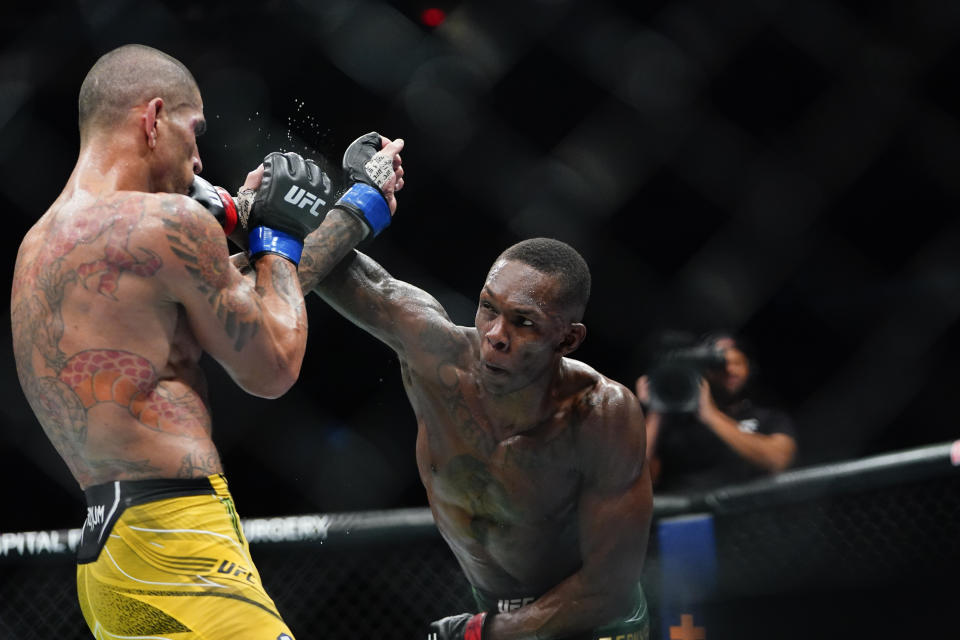 Nigeria's Israel Adesanya, right, punches Brazil's Alex Pereira during the fourth round of a middleweight bout at the UFC 281 mixed martial arts event early Sunday, Nov. 13, 2022, in New York. Pereira stopped Adesanya in the fifth round. (AP Photo/Frank Franklin II)