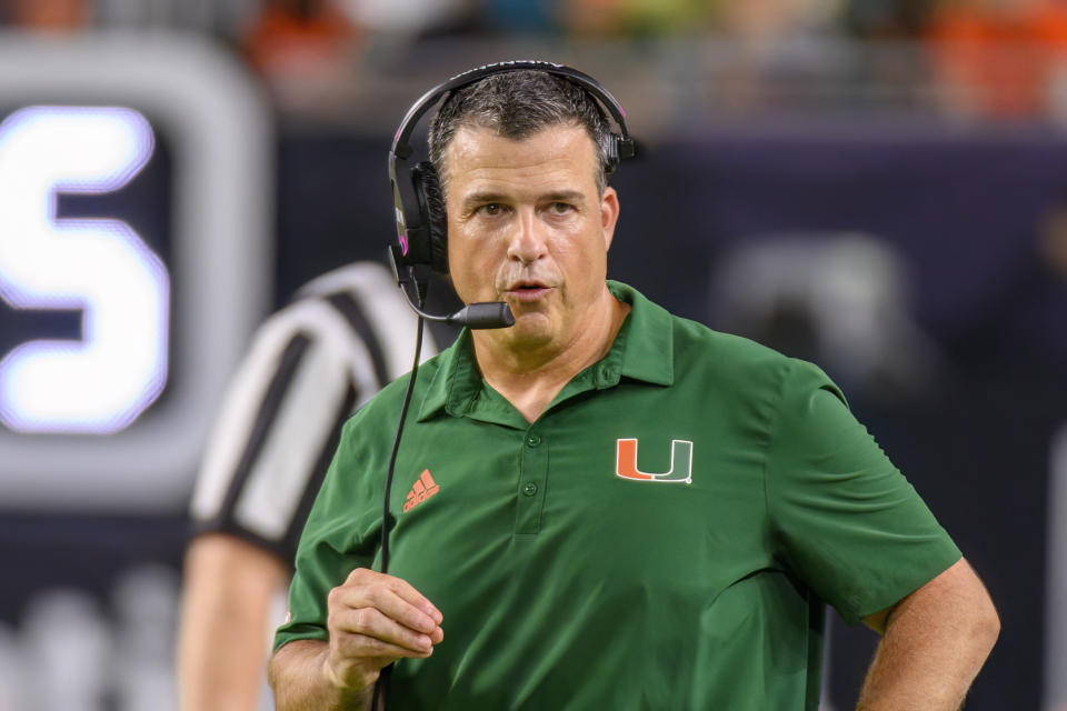 MIAMI GARDENS, FL - NOVEMBER 26: Miami head coach Mario Cristobal talks on his headset during an college football game between the Pittsburgh Panthers and the University of Miami Hurricanes on November 26, 2022 at the Hard Rock Stadium in Miami Gardens, FL. (Photo by Doug Murray/Icon Sportswire via Getty Images)