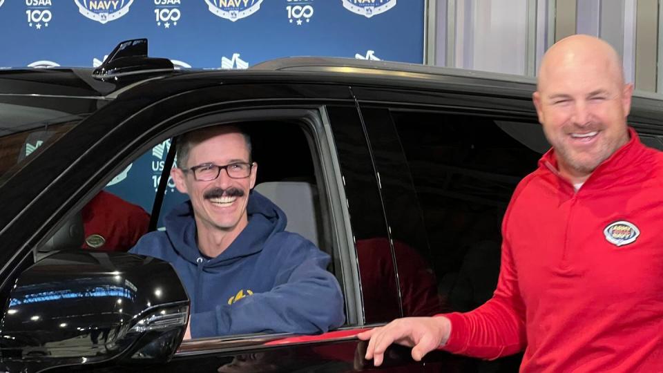 Navy veteran Christopher Andrieu smiling after receiving a Chevrolet Tahoe through the Recycled Rides program run through USAA and partner organizations. (Todd South/Military Times)