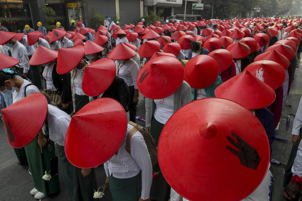 FILE - In this March 3, 2021, file photo, anti-coup school teachers in their uniform and traditional Myanmar-hats participate in a demonstration in Mandalay, Myanmar. The escalation of violence in Myanmar as authorities crack down on protests against the Feb. 1 coup is adding to pressure for more sanctions against the junta, as countries struggle over how to best confront military leaders inured to global condemnation.(AP Photo/File)