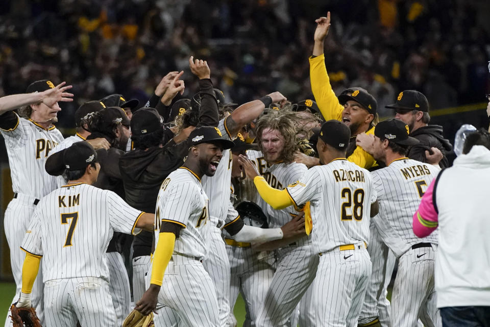 Members of the San Diego Padres celebrate after the Padres defeated the Los Angeles Dodgers 5-3 in Game 4 of a baseball NL Division Series, Saturday, Oct. 15, 2022, in San Diego. (AP Photo/Jae C. Hong)