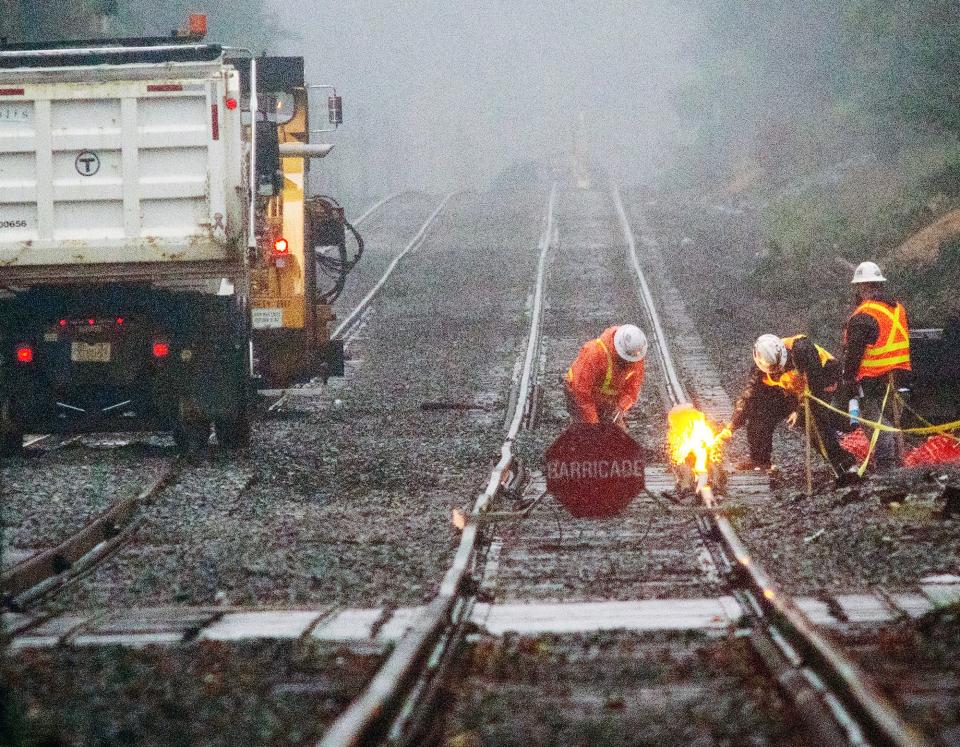 Railroad workers repairs tracks near the North Leominster station Monday.