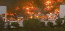 This photo taken from video provided by KABC-TV shows a raging fire destroying a huge commercial building Friday, June 5, 2020 in Redlands, Calif., about 60 miles (96 kilometers) east of Los Angeles. The fire early Friday destroyed a Southern California distribution facility that was used to ship items to Amazon customers but authorities said employees got out and there were no reports of injuries. A half-dozen fire departments were unable to stop flames from destroying the sprawling structure. (KABC-TV via AP)