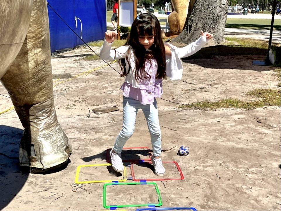 Natalia Barajas of Jacksonville plays hopscotch at the Constellation Furyk & Friends Kids Zone.